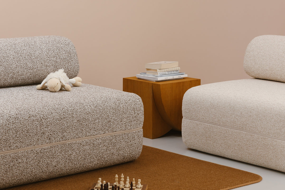 KHOY sofa beds in textured Lux fabric with a side table and soft toy